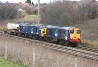 English Electric traction from 50 years ago still at work for DRS with Bo-Bo Type 1 20303 leading and Co-Co Type 3 37087 in tow along with a single nuclear flask wagon. The train is approaching the former station site at Farington on the WCML south of Preston.<br><br>[John McIntyre 25/02/2012]