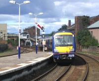 An Edinburgh - Aberdeen DMU pulls away from platform 2 at Arbroath station in August 2006. Arbroath North signal box stands in the background.<br><br>[John Furnevel 09/08/2006]