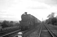 The southern approach to Beattock station on a summer Saturday afternoon in 1962, with Perth based Black 5 no 45099 about to pull into the platform with a down passenger train. The required banking assistance is standing by at the end of the siding on the right.<br><br>[R Sillitto/A Renfrew Collection (Courtesy Bruce McCartney) /07/1962]