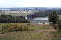 The most notable engineering work on the former line between Woodham Ferrers and Maldon was the Chelmer viaduct that connected Maldon East and West stations. The central span was demolished using explosives in the mid 1960s, but the masonry survived until a new bridge was built to carry the A414 town bypass (opened in 1990). This view, recorded in 1978, shows the viaduct brickwork as it appeared from the Maldon West side of the river. <br><br>[Mark Dufton 23/07/1978]