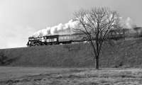 The afternoon sun glints off 2-6-2 No. Ol49-32 near Lipiny, Poland, on the 15.27 Wolsztyn - Nowa Sol train in March 1993. The angle of the photograph hides the fact that the train was composed of only two coaches - a featherweight load for such a powerful locomotive.<br><br>[Bill Jamieson 27/03/1993]