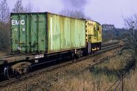 Class 10 <I>'Colonel Tomline'</I> (D3489) pulls a rake of container wagons through Felixstowe Beach station on 14th April 1984. It is about to reverse the wagons into a siding to clear the path for an incoming container train. This well known locomotive was eventually retired from the docks in 2001 after almost 32 years of service there and is now preserved on the Spa Valley Railway.<br><br>[Mark Dufton 14/04/1984]