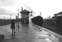 The grimmest of weather on 16th April 1966 as a northbound WCML train runs into Carstairs station.<br><br>[Frank Spaven Collection (Courtesy David Spaven) 16/04/1966]