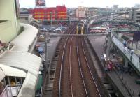 A 'Slim Jim' leaves Manila's EDSA station on LRT Line 2, surrounded by competing modes of transport (coach, Jeepneys, motorcycle taxis, bicycle taxis, a minicab, and even an aeroplane). Notice the Lego-style building in the left background.<br><br>[Ken Strachan 11/01/2012]