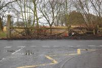 Surviving gate of the Hugo branch level crossing on the A955 in Coaltown of Wemyss, photographed in February 2012. This line served the Hugo Depot at the northern end of a railway tunnel from the Victoria Pit on the foreshore at West Wemyss [see image 37854].<br><br>[Bill Roberton 27/02/2012]