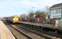 The driver of a brace of Class 20s collects the single line staff and ground frame keys from the Bare Lane signalman before proceeding to Heysham Power Station to collect a re-processing load for Sellafield. The Type 1s had been waiting on the Hest Bank chord for the Heysham Boat Train to clear the section. When this signal box closed in 2012 control passed to Preston power box and the staff was no longer required.<br><br>[Mark Bartlett 06/03/2012]