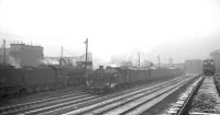 An unidentified V3 2-6-2T with a westbound parcels train passes Gateshead shed between Greensfield and King Edward Bridge Junction, thought to be in the early 1960s. The original 1862 shed at Chaytor's Bank stands in the right background - the roundhouse latterly serving as the Gateshead Works paint shop.<br><br>[K A Gray //]
