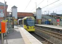 Photos of Timperley station in BR days show an elegant covered footbridge leading to both platforms from the street level booking office. The footbridge has been removed now and access to the platform is by either the two lifts shown or staircases while the old booking office is now a cafe. M5000 Series tram No.3002 leaves the station on 8 March heading for Navigation Road and Altrincham. <br><br>[Mark Bartlett 08/03/2012]