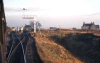 Two trains cross at Altnabreac in November 1963 before the loop was taken out - although the water column survived until the early 1970s. [Actually the mid 1990s. Ed.] The stations's 'walk-in catchment' comprised the building to the right and the hunting/shooting/fishing Lochdhu Inn, two miles south by Land Rover track. This scene is now surrounded by forestry plantations.<br><br>[Frank Spaven Collection (Courtesy David Spaven) /11/1963]