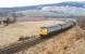 A DMU westbound past the site of Orton station on a March afternoon in 1979. The River Spey bridge stands in the background, with the trackbed of the long gone line from Orton to Rothes to the right [see image 25801]. <br><br>[Peter Todd 30/03/1979]