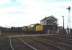 A class 37 hauled container train runs over the level crossing at March South Junction in June 1997 heading south east towards Felixstowe.<br><br>[Ian Dinmore /06/1997]