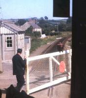 The train guard opens level crossing gates on the Maiden Newton-Bridport branch in Summer 1971 - the closure of the line four years later would represent the very belated end of the Beeching cuts [see image 29077].<br><br>[David Spaven //1971]