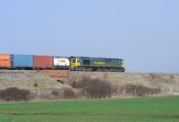 A container train heading east out of Swindon passes Longcot on 15 March 2012. Locomotive is Freightliner 66594.<br><br>[Peter Todd 15/03/2012]