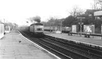 Pigeon dispersal at Ealing Broadway. A Brush Type 4 opens up with a westbound freight through platform 3 at Ealing Broadway station in April 1981. The train has recently joined the ex-GW main line after descending the bank from the North London Line at Acton Wells Junction in the distance. Meantime a sister locomotive is about to run through platform 1 on the down fast line at the head of a Paddington - Bristol express.<br><br>[John Furnevel 29/04/1981]