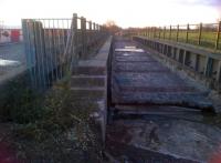 Since 1959, there has been a most unusual bridge across the M50 motorway near Ripple, Worcestershire. Four identical channel sections cover both sides of the motorway, supporting at first a single-track road (L) and a single-track railway running between Tewkesbury and Malvern. Sadly, the bridge is currently being demolished. Following a 32-week closure, the road link between the throbbing metropoli of Puckrup and Ripple will be re-opened. [See image 39127]<br><br>[Ken Strachan 18/03/2012]