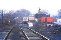 A DMU from Huddersfield stands at the terminus at Clayton West in February 1974 with an NCL truck in attendance. <br><br>[Ian Dinmore /02/1974]