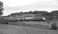 On 21st September 1974 there were two railtours plying Furness Railway metals with steam power between Carnforth and Ravenglass. 'The White Rose' had originated in Leicester and was powered by A3 No. 4472 <I>Flying Scotsman</I> and Black 5 No. 44932 double heading tender to tender in the outward direction. The train was returned to Carnforth by Class 40 No. 40013 (formerly <I>Andania</I>), seen here just north of Silverdale station [with thanks to Vic Smith].<br><br>[Bill Jamieson 21/09/1974]