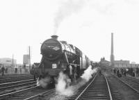 Stanier 8F no 48773 makes a photostop at Broadfield station on 20 April 1968 with the MRTS/SVRS <I>North West Tour</I> which had originated from Birmingham New Street. The tall chimney in the background is part of Heywood's Unity Mill.<br><br>[K A Gray 20/04/1968]