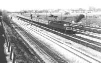 A maroon 'Western' diesel hydraulic locomotive photographed shortly after passing through Ealing Broadway and approaching Acton Main Line in March 1969 with a service from Plymouth. The train has approximately four and a half miles to run to its ultimate destination at Paddington.<br><br>[John Furnevel 18/03/1969]