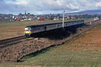 The 09.25 Glasgow Queen Street to Aberdeen ScotRail Express hauled by 47 703 speeds past Blackford village in April 1989, its DBSO at the rear. The following year, an hourly service of Class 158 DMUs replaced these �push-pull� sets. The DBSOs ended up paired with Class 86 locos on the (then) newly electrified London to Norwich service.<br><br>[Mark Dufton /04/1989]