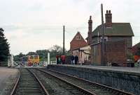 A few local inhabitants have turned out to see the unusual sight of a passenger train visiting Ryburgh station in October 1980. The train (two Cravens sets comprising the F&DRS Central Norfolk Freight Lines railtour) has just drawn up at the crossing gates and will shortly pull into the platform. That will be the limit of its travel on this line, because the next section to Fakenham had been closed recently and was in the process of being dismantled. Less than a year later, Ryburgh station became a casualty itself when the adjacent maltings transferred all its goods to road.<br><br>[Mark Dufton 11/10/1980]