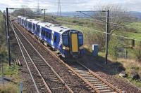 380 104 passes the site of Camps Junction signalbox and level crossing with the 15.14 from Glasgow Central to Edinburgh on 31 March. The gate on the right is on the formation of the Camps branch which served a goods station and quarries.<br><br>[Bill Roberton 31/03/2012]