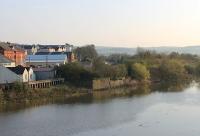 A <I>Then and Now</I> comparison with the 1971 view of the bridge over the River Towy in Carmarthen [see image 36249]. The old railway bridge and its pillars have gone although the abutment on the far bank can just be seen, as can the remains of the first Carmarthen station, which lingered on for goods traffic into the early 1970s. The approach road for the surviving station is just behind the camera.  <br><br>[Mark Bartlett 24/03/2012]