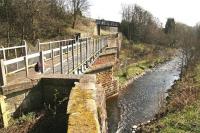 View south over the Gala Water from Kilnknowe Junction about a mile short of the site of Galashiels station on 26 March 2012. The road overbridge in the background carries Plumtreehall Brae. [See image 38187]<br><br>[John Furnevel 26/03/2012]