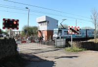 Hagside signal box was built by BR in 1978 and replaced an old L&YR box at this level crossing near Radcliffe, and others nearby. With conversion to the tram system the crossing, the only one controlled by Metrolink, became automatic and the box redundant although the adjoining relay rooms are still operational. A tram passes heading for Bury on 26 March 2012. <br><br>[Mark Bartlett 26/03/2012]