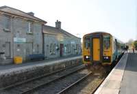 A Cardiff to Shrewsbury (Heart of Wales line) service pauses in the passing loop at Llandovery station while the driver exchanges single line tokens. ATW single unit 153367 stands opposite the refurbished station building, formally re-opened by the Prince of Wales in June 2011 after many years of disuse. The crew will continue to Llanwrtyd where they will swap trains with a Shrewsbury crew and return south.<br><br>[Mark Bartlett 24/03/2012]