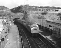 An unidentified class 40 runs through North Queensferry station at around 10.00 on the morning of Saturday 25th March 1978. Judging by the the early Mark 2 coaches and buffet car the train will have originated in Aberdeen. A4 No. 60009 will shortly pass through on a northbound special, hence the odd photographer to be seen lurking!<br><br>[Bill Jamieson 25/03/1978]