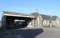 The 1864 branch terminus at Pembroke Dock is still an attractive building, with part of it now converted into 'The Station Inn', a specialist real ale pub. The branch train can just be seen through the canopied platform entrance. On this occasion it is a single 153 unit heading for Carmarthen and Swansea, although the line also sees through services to Manchester Piccadilly using ATW Class 175s.<br><br>[Mark Bartlett 23/03/2012]