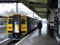 158903 waits at the platform at Wakefield Westgate on 4 April for a 142 Pacer (seen in the distance) to clear the section and allow it to run forward to the down side turnback siding. The 158 had recently arrived with the 11.08 service from Leeds via Bradford and Huddersfield.<br><br>[David Pesterfield 04/04/2012]