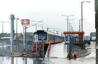 View of the newly opened Ardrossan Harbour station on a rainy day in January 1987. At the platform with an imminent departure for Glasgow Central is a hybrid DMU  made up of two Derby heavyweight 107s and a Metro-Cammell 101 at the far end.<br><br>[Colin Miller /01/1987]