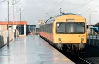 A Metro Cammell 101 with 2 Derby Heavyweight 107s behind forming the next train to Glasgow Central from the newly opened Ardrossan Harbour station on a wet day in early January 1987. <br><br>[Colin Miller /01/1987]