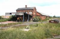 London Road station, Carlisle, looking east in 2003. Opened in March 1836 by the Newcastle & Carlisle Railway it was also used by Lancaster & Carlisle and Maryport & Carlisle trains for a time prior to the opening of Citadel station. Following the diversion of the N&C passenger services to Citadel in 1863 it became a goods depot. The old building is seen here abandoned in May 2003, following a period of use as a fertiliser warehouse.<br><br>[John Furnevel 25/05/2003]