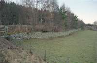 View north at Dandaleith. The station has been obliterated by a road re-alignment and was located above the retaining wall shown here. Dandaleith was the southern terminus of the Morayshire Railway and was called Craigellachie from 1858 until the line's extension to Craigellachie on the Strathspey Railway in 1865. View looks to Elgin in 1997.<br><br>[Ewan Crawford 02/02/1997]