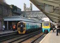 A member of staff waiting for a second Arriva 158 unit to couple on to 158833 makes for an unusual sight amid Shrewsbury's architecture. The combined train left shortly afterwards for Aberystwith while 175103 on the right was on a service to Holyhead. <br><br>[Mark Bartlett 24/03/2012]
