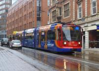Wet and miserable-looking <I>'Stagecoach Supertram'</I> no 122, running through Sheffield city centre on 9 April 2012. <br><br>[Bruce McCartney 09/04/2012]