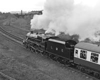 Black 5 No. 5305 accelerates the HLPG special away from Wortley Junction in the direction of Harrogate on 30 April 1977. Although reporting numbers were no longer displayed on locomotives by 1977, 1G01 appears in the leading window of the first coach - no doubt still useful for identifying the correct rake of vehicles in the carriage sidings although it seems unlikely that there would be many other specials arriving at Scarborough on the same day so early in the season. <br><br>[Bill Jamieson 30/04/1977]