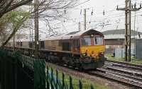 A quartet of DBS 66s head south through Preston on Easter Monday 2012, presumably after weekend engineering duties. 66187 led the way followed by 66140 and 66105 with 66204 bringing up the rear. The four locos are seen passing Fylde Junction with Preston power box behind. <br><br>[Mark Bartlett 09/04/2012]