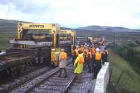 Guests of BR from Inverness enjoy a close-up view of a track laying machine just south of Dalwhinnie in 1976.<br><br>[Frank Spaven Collection (Courtesy David Spaven) //1976]