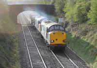 DRS Class 37s 37069 and 37608 accelerate through Warton near Carnforth with a train from Crewe conveying three nuclear flasks for reprocessing at Sellafield. <br><br>[Mark Bartlett 11/04/2012]