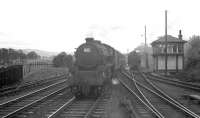 Black 5 no 45479 approaching Beattock station with a northbound train on a summer evening in 1963. The train is passing Beattock south signal box, alongside which one of the shed's banking locomotives is taking on water.<br><br>[R Sillitto/A Renfrew Collection (Courtesy Bruce McCartney) /07/1963]