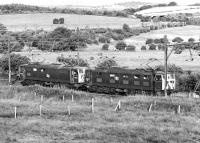 The very last Worsborough bankers? 76 012 and 76 007 about to buffer up at the rear of a Wath Yard to Fiddler's Ferrry MGR coal train at Wombwell Main Junction on 17 July 1981. The train locos are visible in the distance and, beyond them, the bridge carrying the ex L&Y Barnsley - Sheffield line over the Wath to Penistone electrified section.<br><br>[Bill Jamieson 17/07/1981]