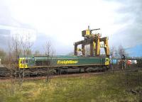 Despite the Freightliner depot at Portobello closing 25 years ago, the <br>
sign and crane remain : and Freightliner Heavy Haul freights again pass <br>
the site, bringing coal from Leith Docks. Photograph taken on 14 April from a train on the main line.<br><br>[John Yellowlees 14/04/2012]