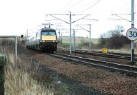 An east coast service slowly joins the single track east to west curve at Carstairs East Junction (formerly Dolphinton Junction) in 2004. The view looks east.<br><br>[Ewan Crawford 22/12/2004]