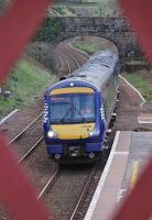 Framed by the latticework of Gleneagles station footbridge, 170426 speeds through on 12 April 2012 with the 15.10 Glasgow Queen Street - Inverness.<br><br>[Bill Roberton 12/04/2012]