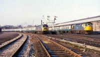 In this 1970s view at Inverness a Class 26 is propelling a train from the north into Platform 3 or 4, while a Class 47 prepares to depart from platform 1 with the Up 'Clansman'. The two sidings to the left were used for Motorail traffic.<br><br>[David Spaven //]