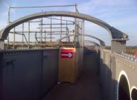 It's not every day you see a diversion on a footbridge. The stairs behind the hoarding were constructed to allow construction workers on Nuneaton's North Chord project to cross the Birmingham line safely.<br><br>[Ken Strachan 25/02/2012]